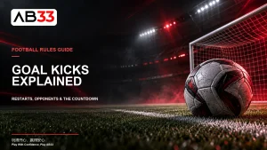 AB33 football goal kicks cover with a ball beside a goal-area line in a floodlit stadium.